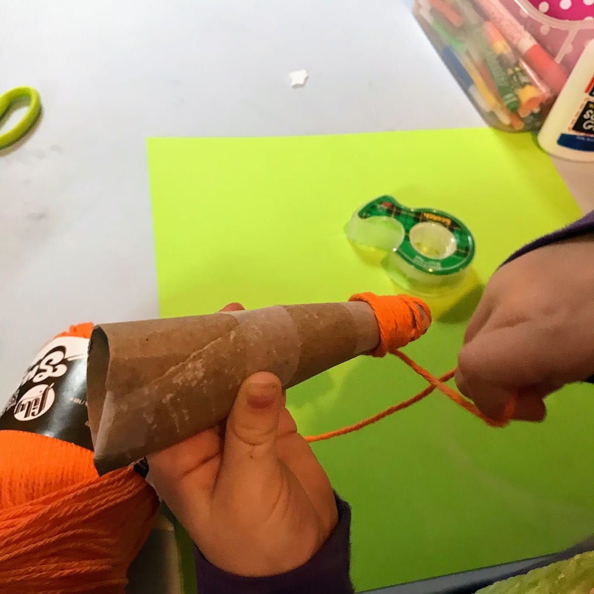 wrapping yarn around paper carrot