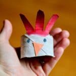 chicken head made from toilet paper roll and paint in child's hand
