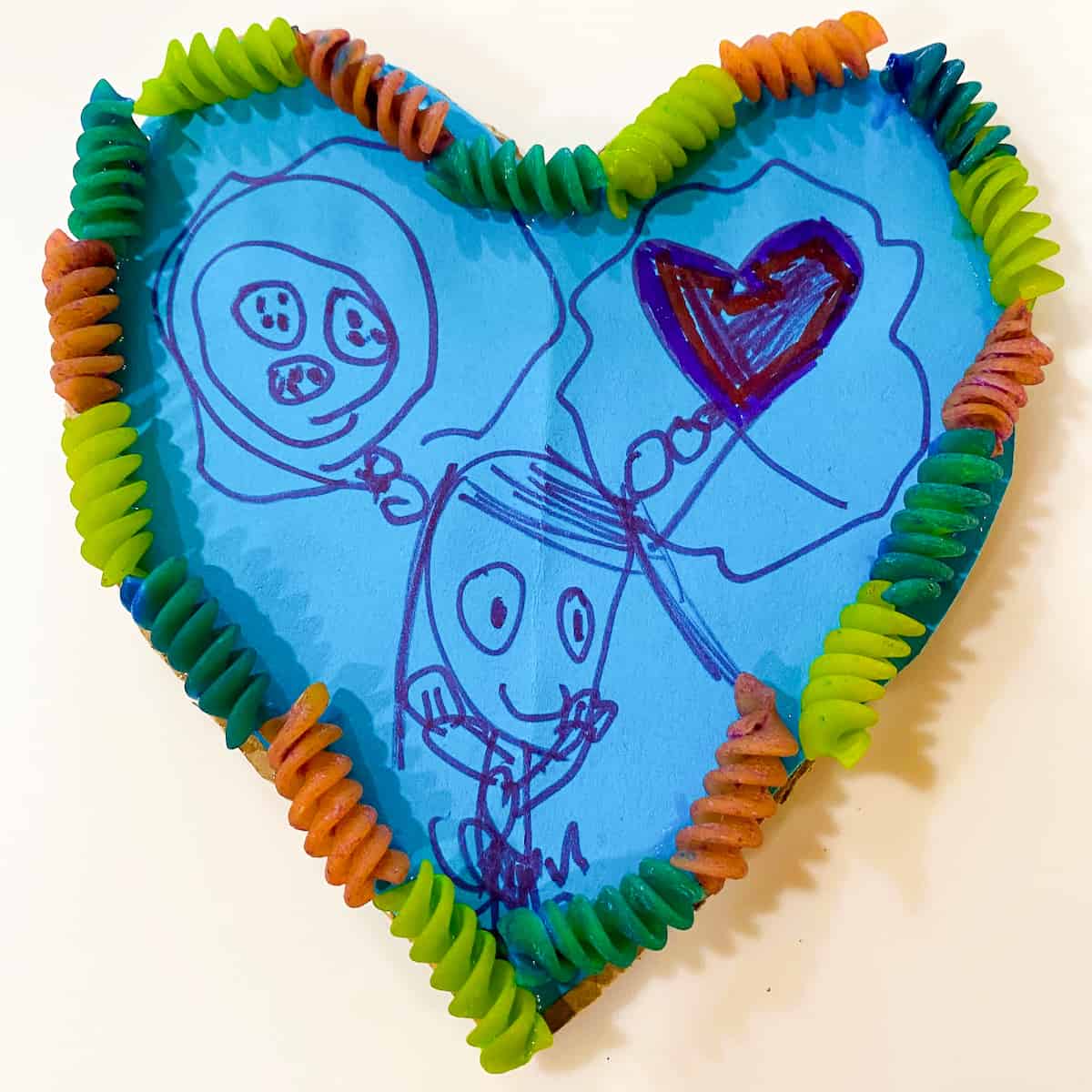 kids blue picture in heart shaped frame made of pasta