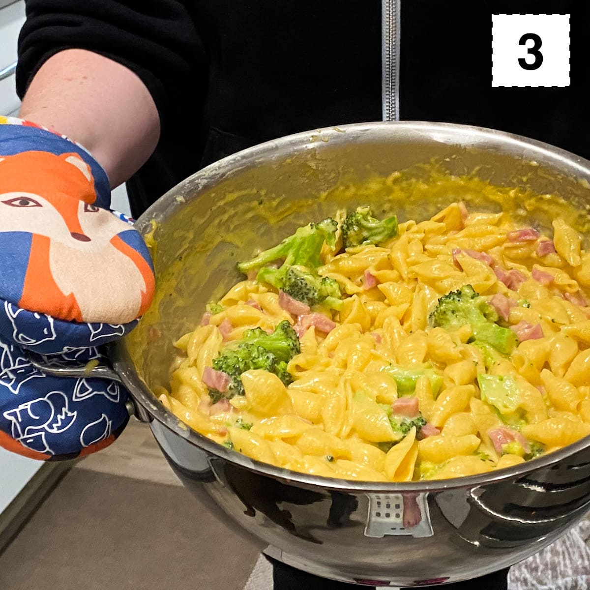 dutch oven filled with creamy mac and cheese with ham and broccoli