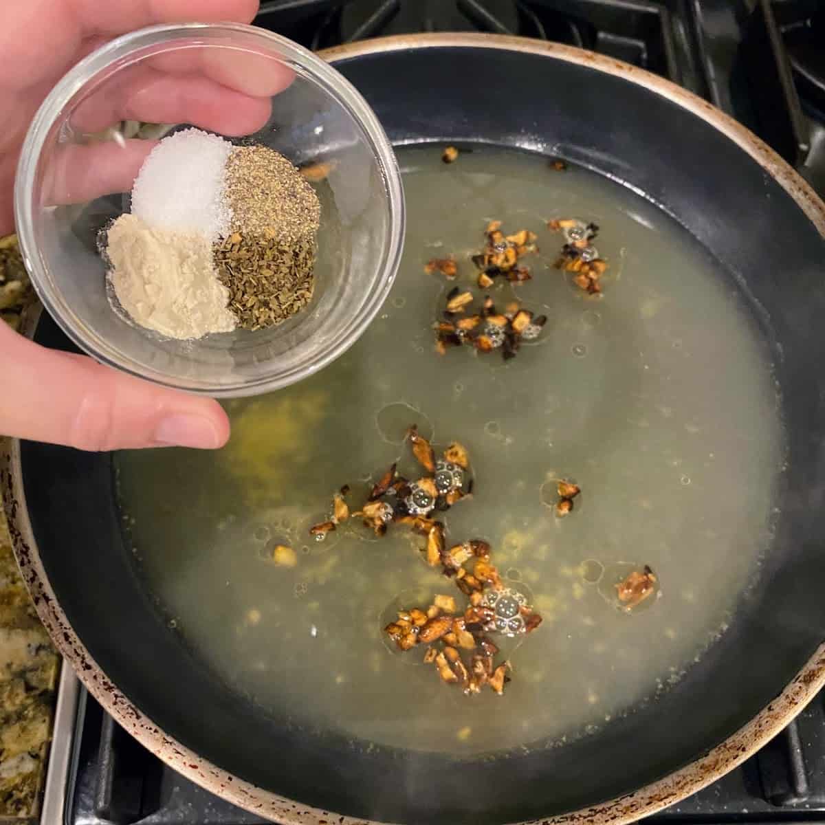 adding seasoning mixture  to pan 