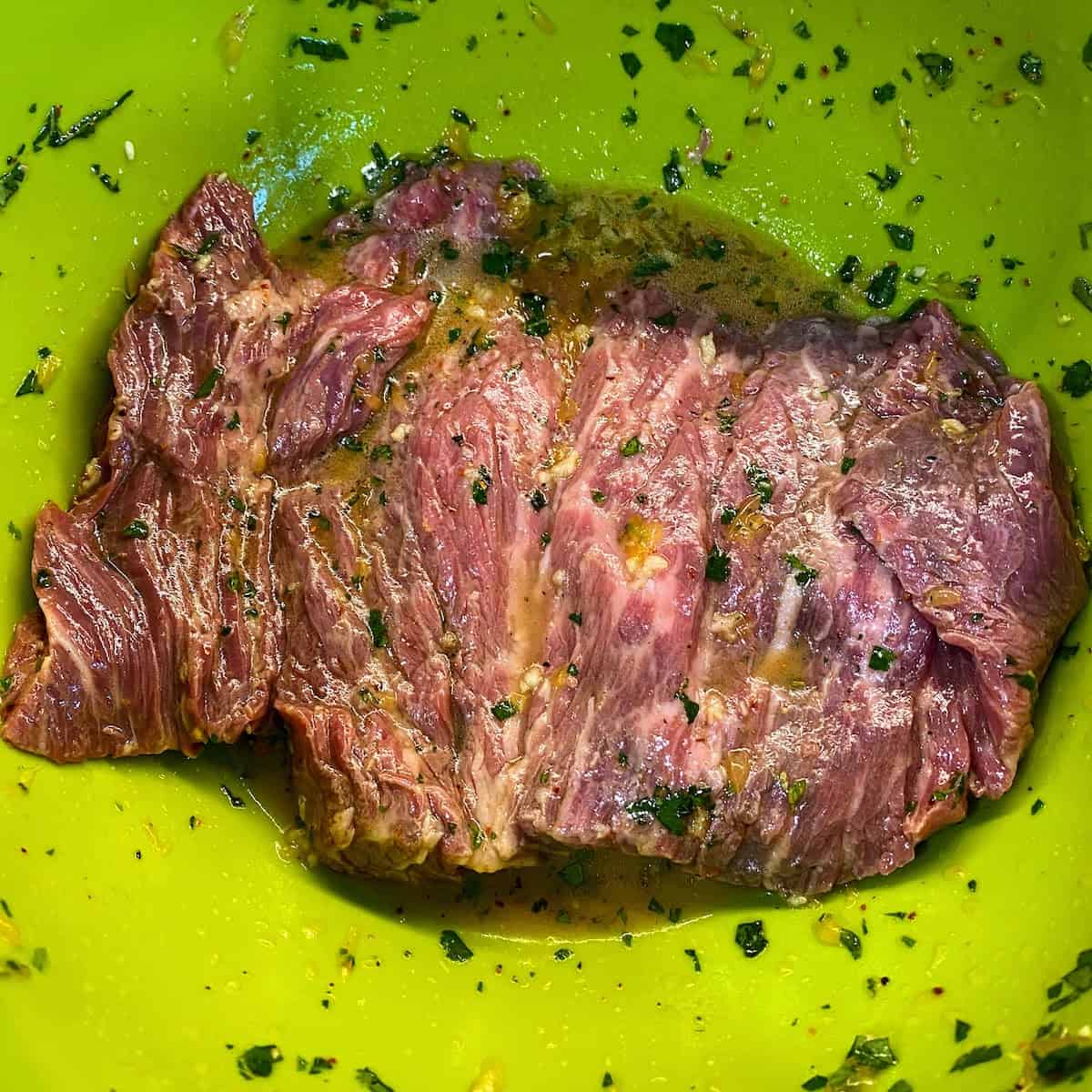 steak marinating in bowl