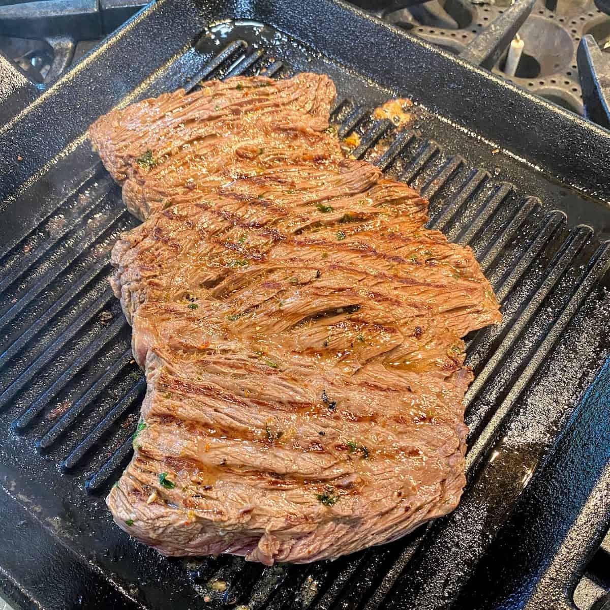 grilling carne asada meat on pan 