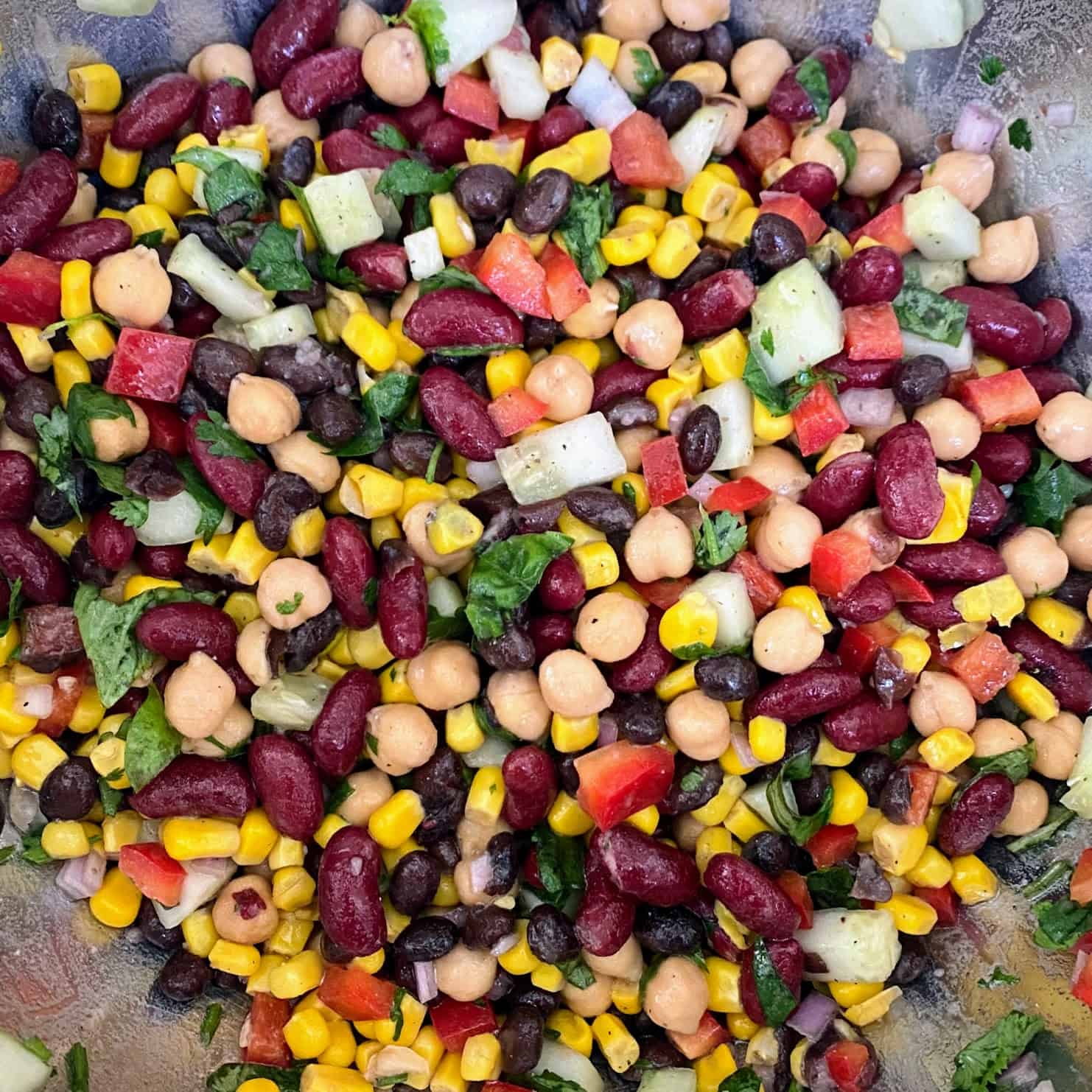 vegan bean salad tossed in dressing 