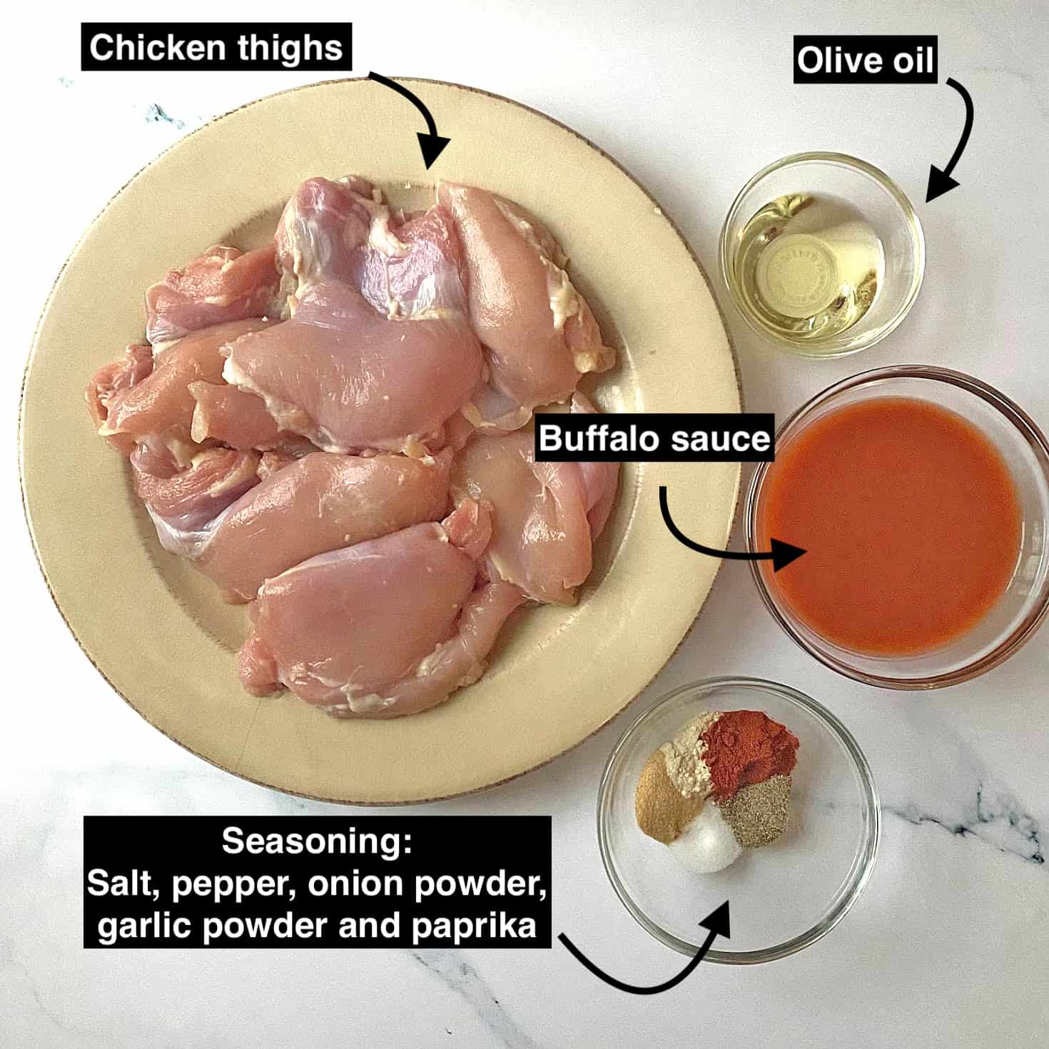 Ingredients for buffalo chicken thighs on a white slab. 