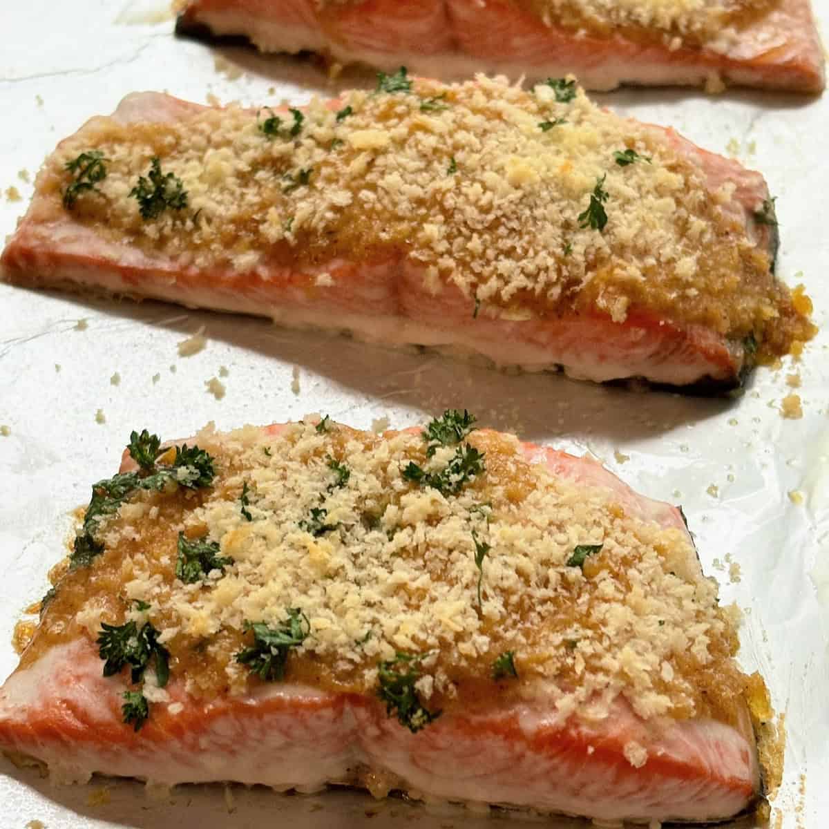Closeup of three honey mustard salmon filets.