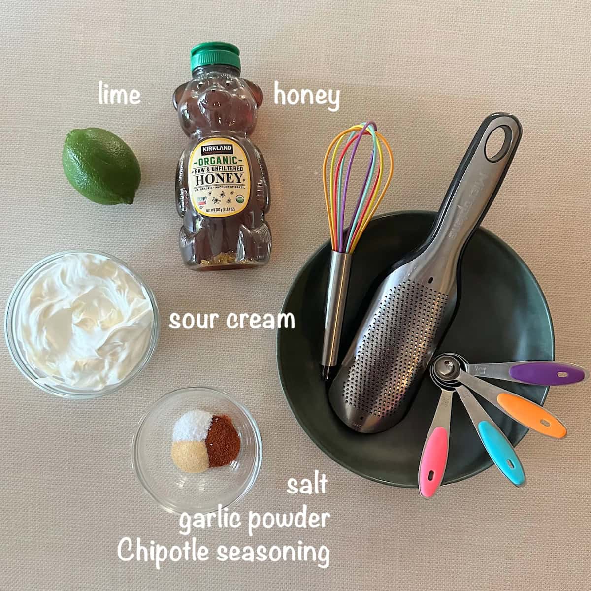 ingredients to make chipotle crema on a cream colored counter