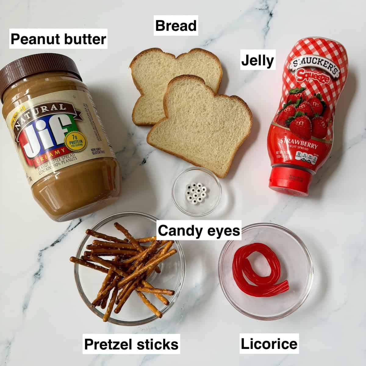 Labeled photo of ingredients for spider peanut butter and jelly sandwiches.