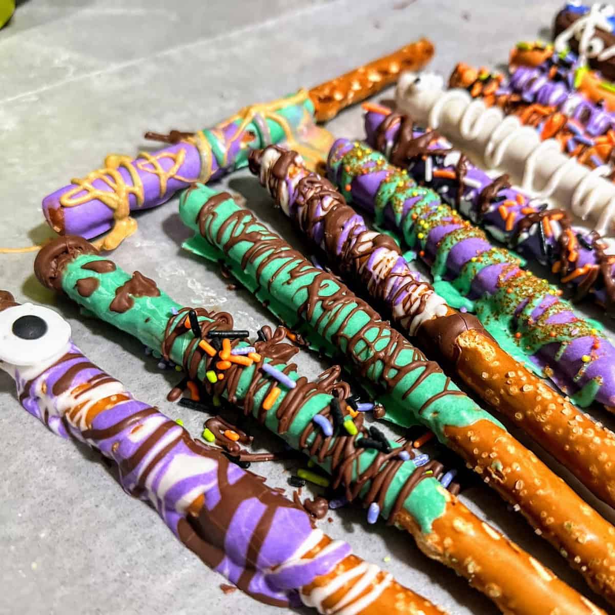 row of pretzels coated in colors and sprinkles