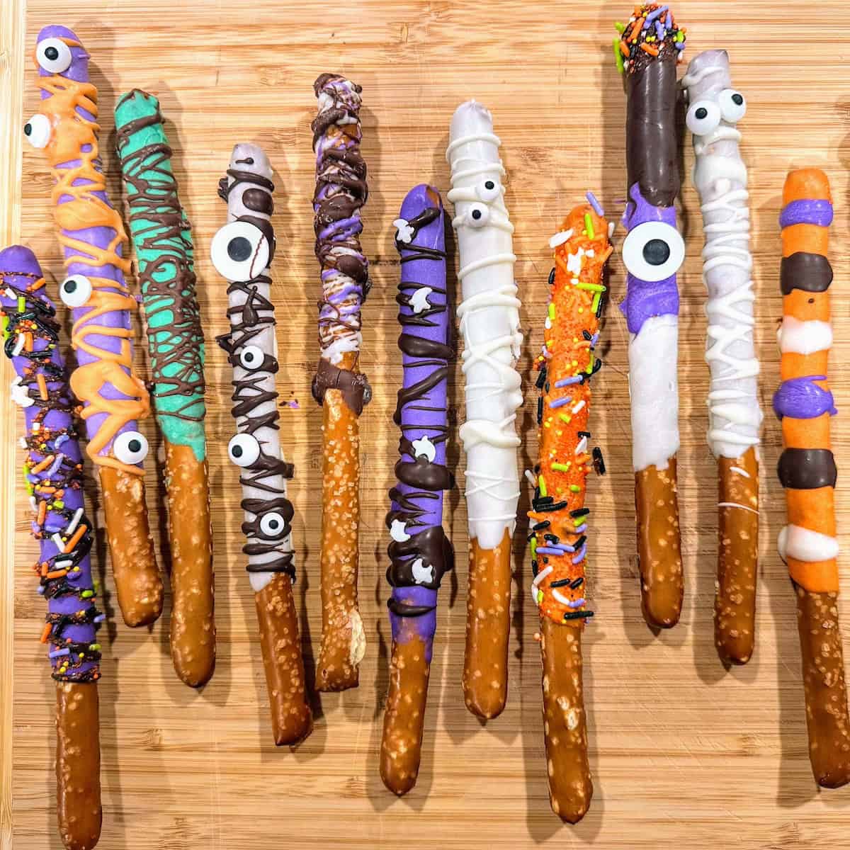 row of Halloween pretzels with fun colors and decorations