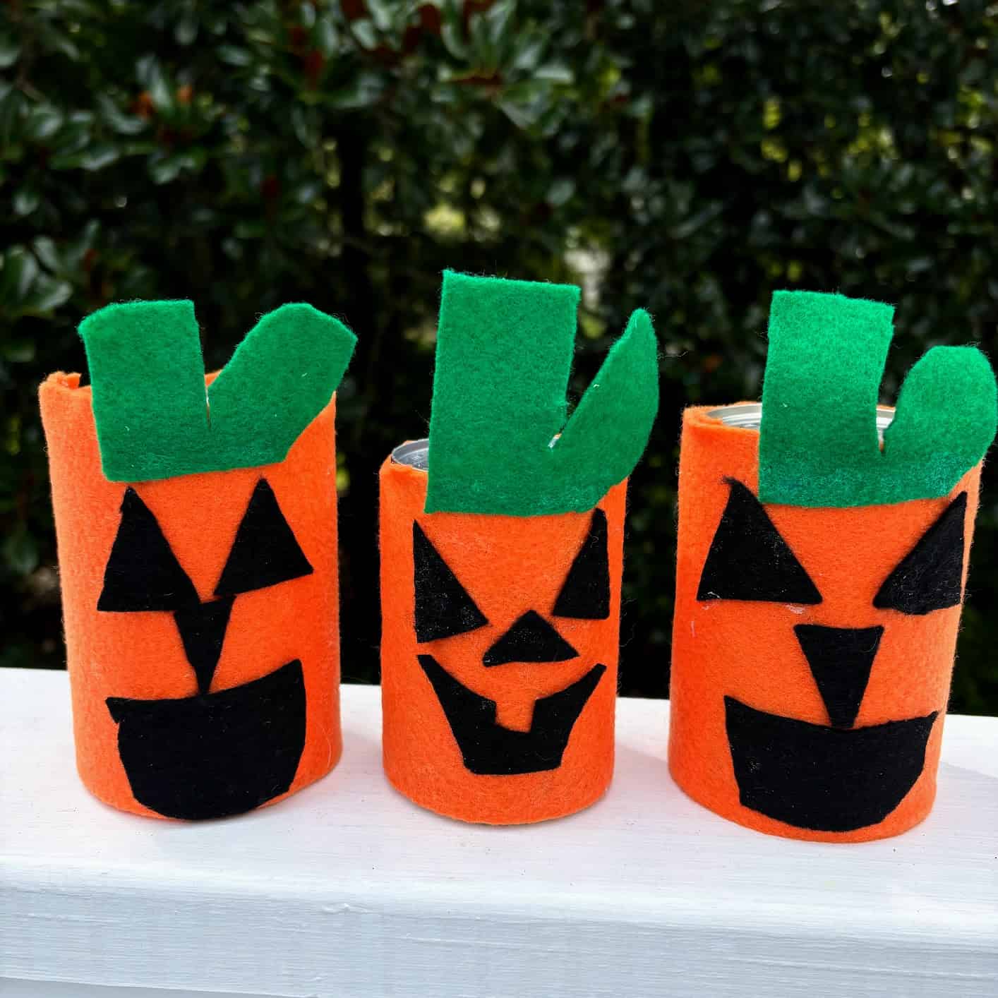 Three pumpkins made from thin cans and felt. 