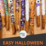 Halloween pretzel rods made with melted chocolate, sprinkles and candy eyes.