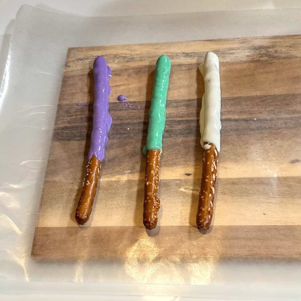 three different color coated pretzel rods