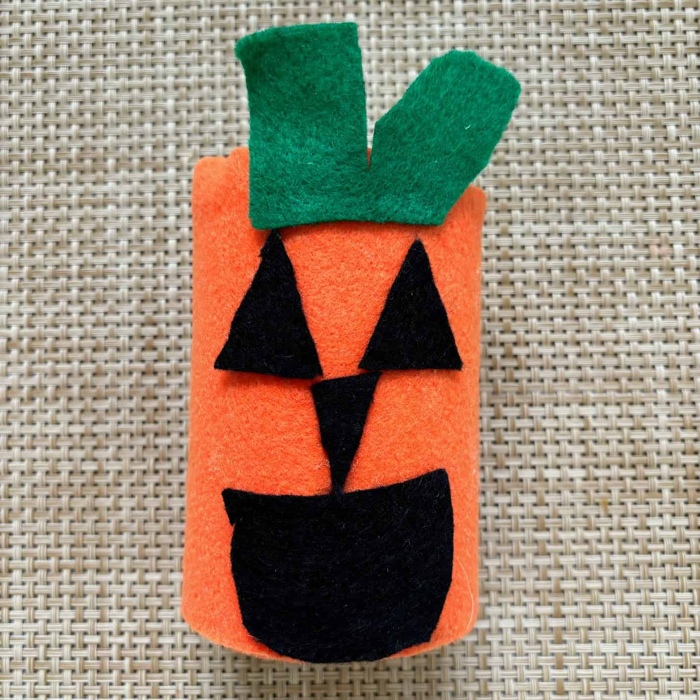 Can covered with orange, black and green felt to look like a pumpkin. 