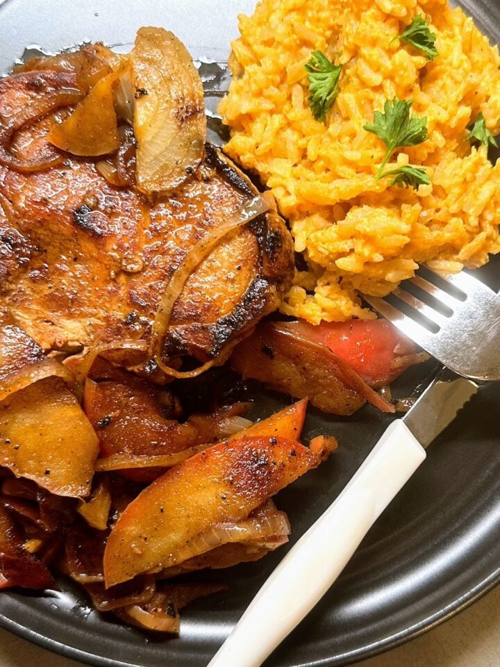 overhead shot of brown sugar brined pork chops with spiced apple and rice