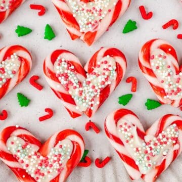 Heart shaped candle canes with white chocolate and sprinkles.