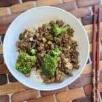 Ground beef teriyaki in white bowl on wooden placemat.