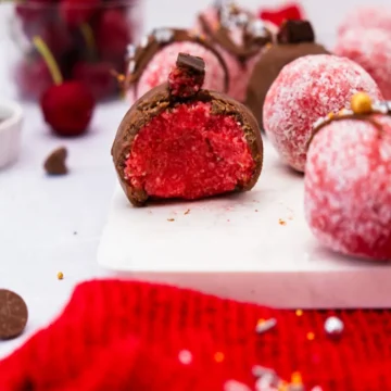 Several cherry ripe balls on a white countertop.