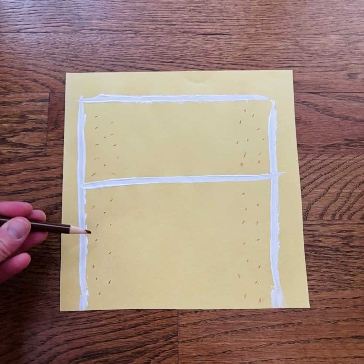 Adding brown dots to yellow square paper.