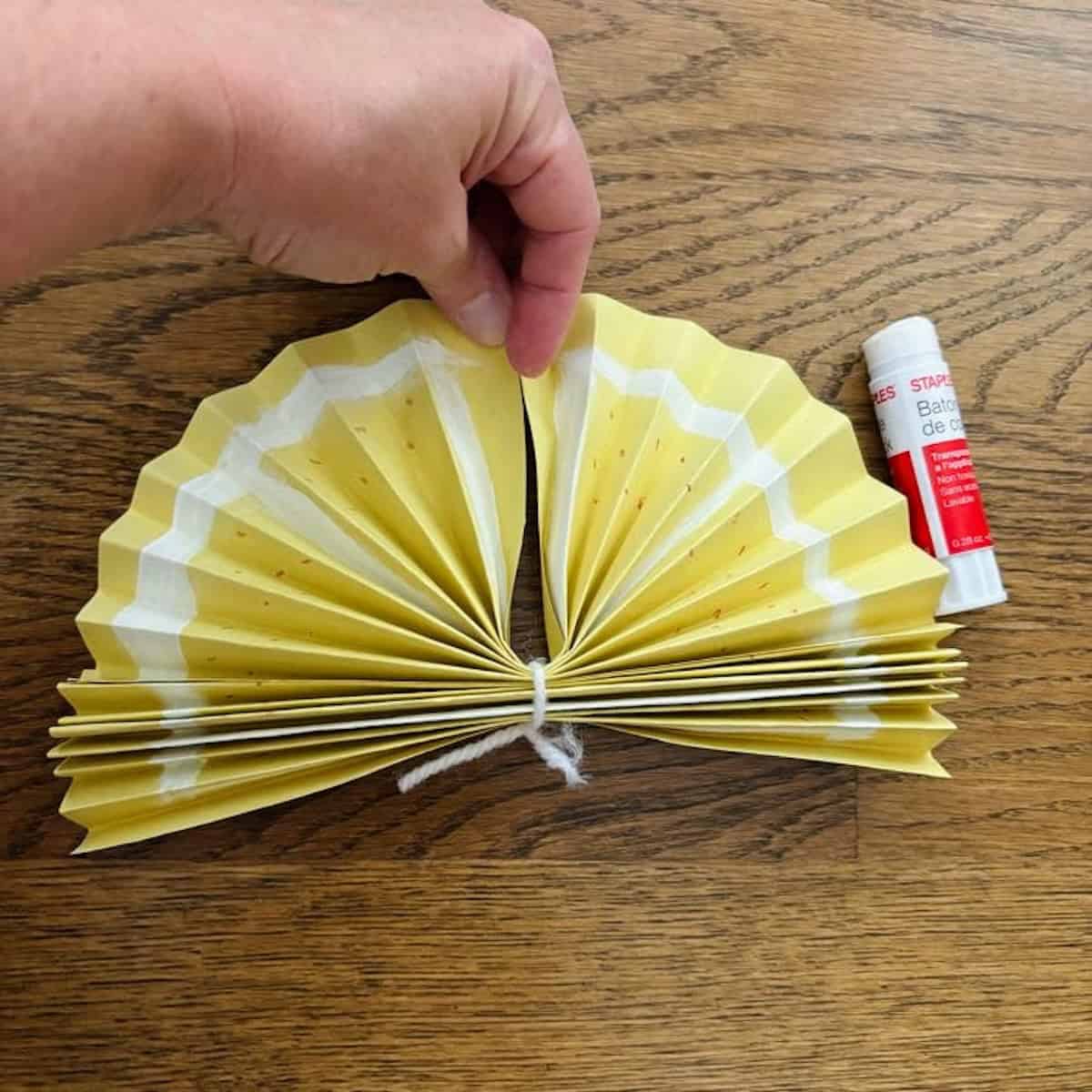 A yellow fan with sides glued together.