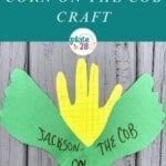 Paper corn craft made from yellow handprint and two green paper footprints.