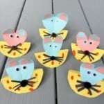 Six paper mice crafts that look like they are eating cheese.