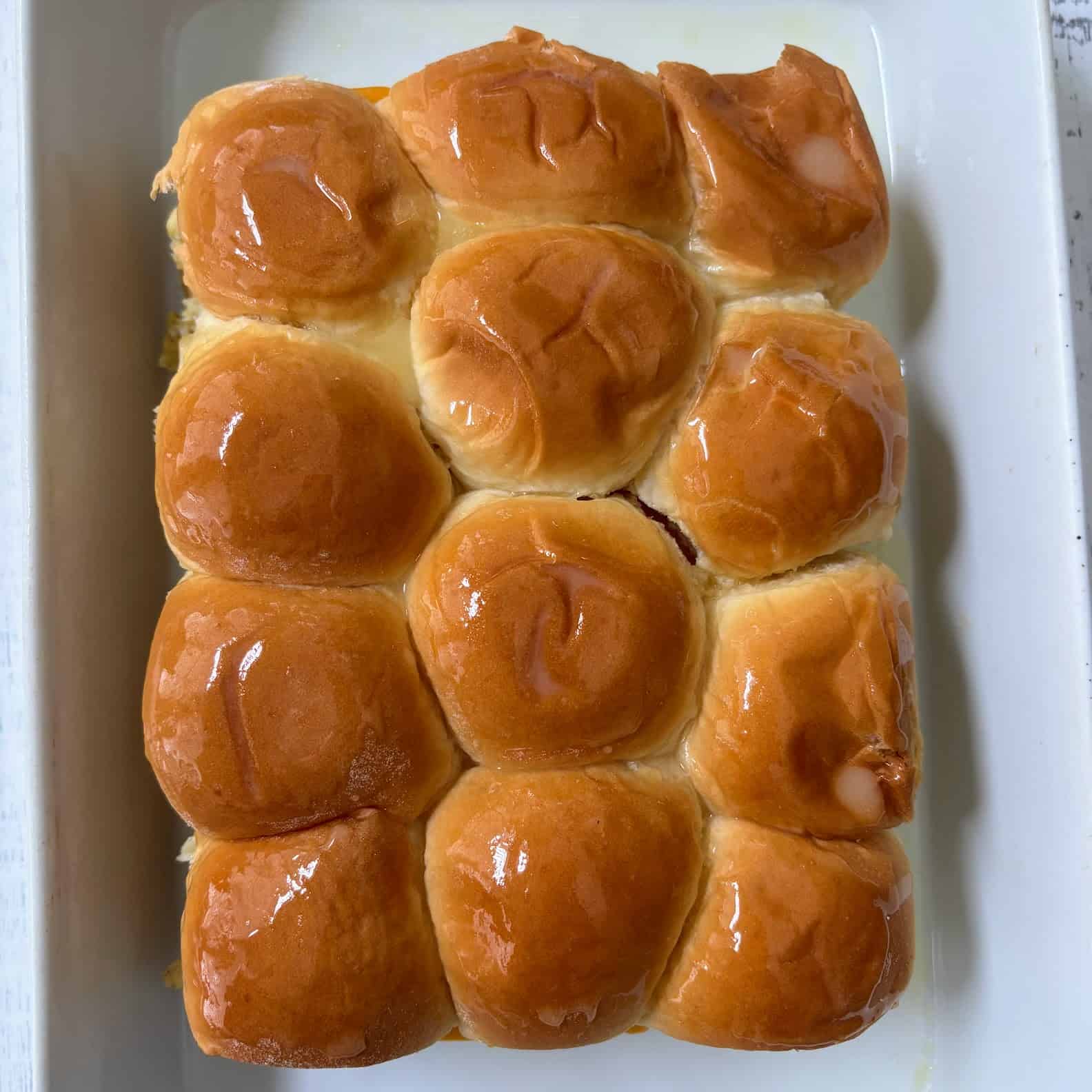 Breakfast sliders on Hawaiian rolls topped with a maple butter glaze.