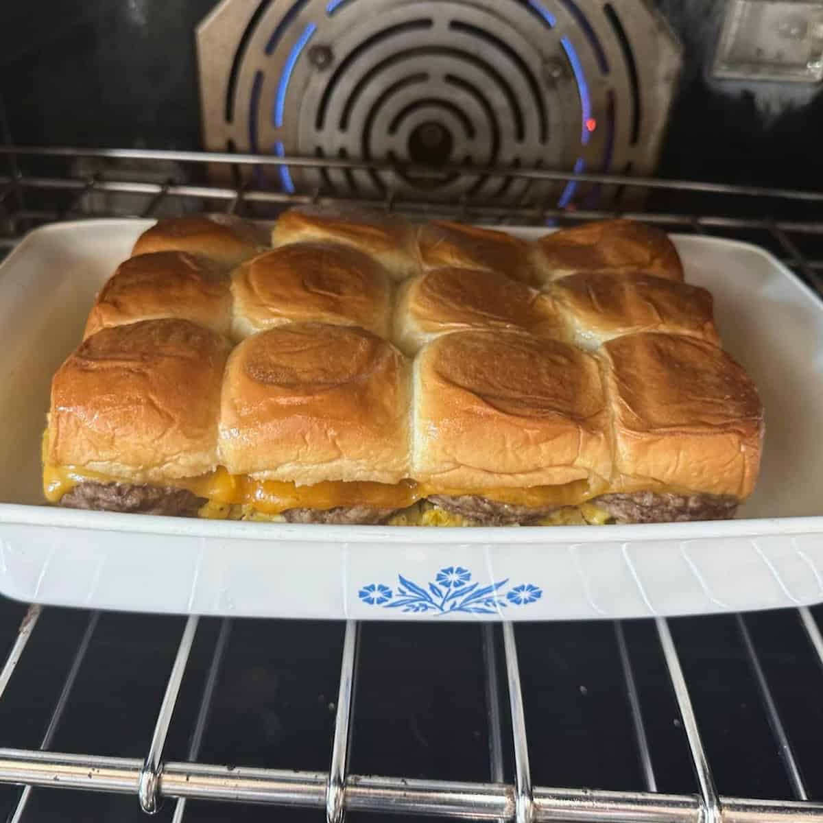 Sausage, egg and cheese mini sandwiches in oven. 