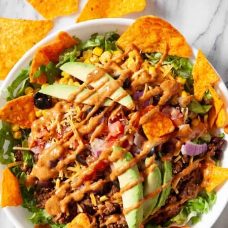A Dorito taco salad with veggies and ground turkey.