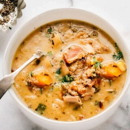 A bowl of ground turkey soup in a white bowl.