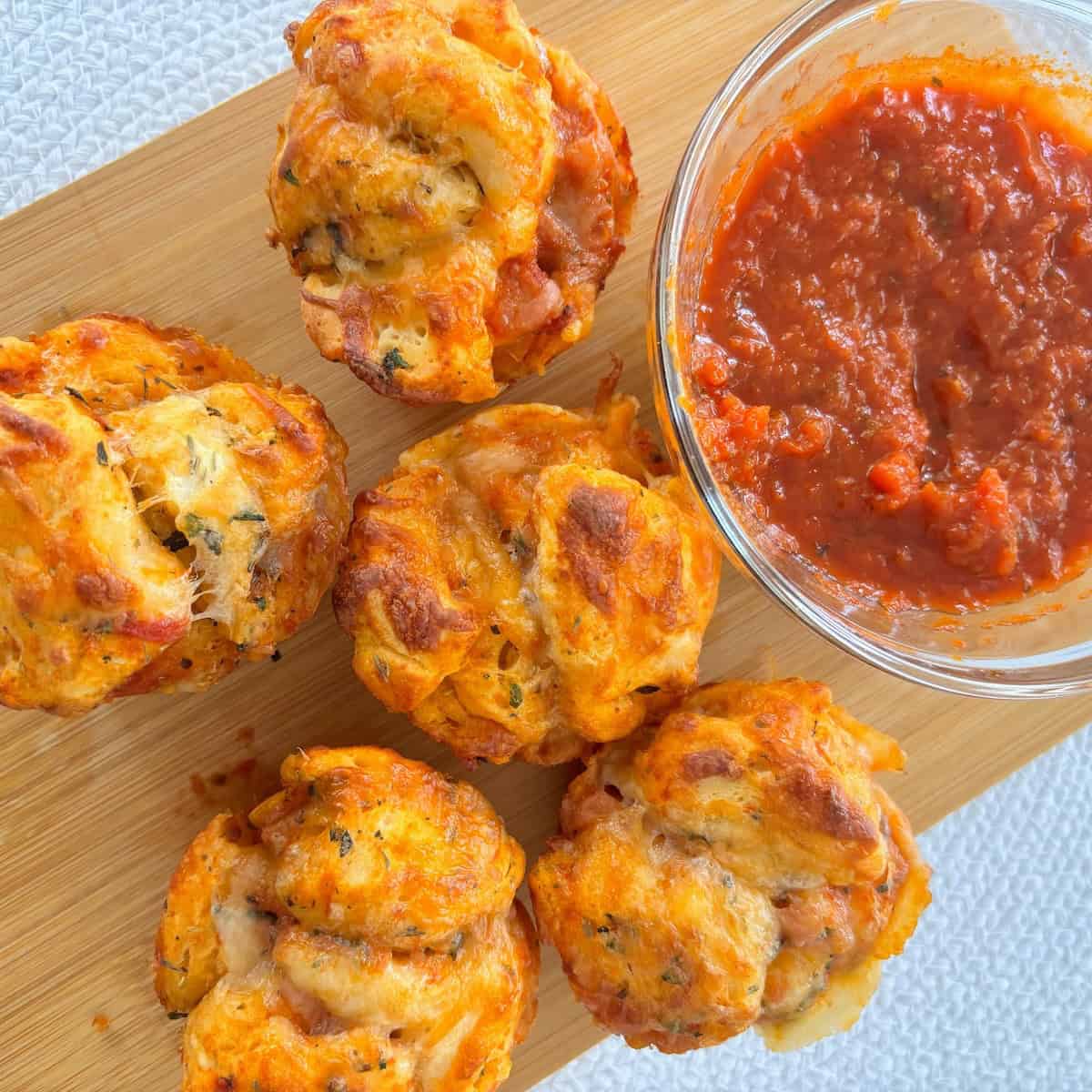 Pizza bites set out on a cutting board.