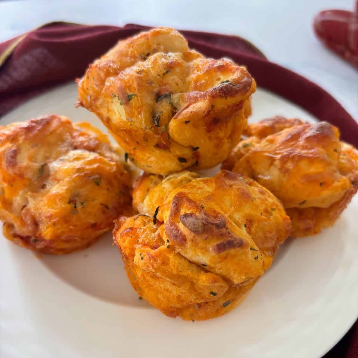 Four stacked pizza muffins made with biscuits.