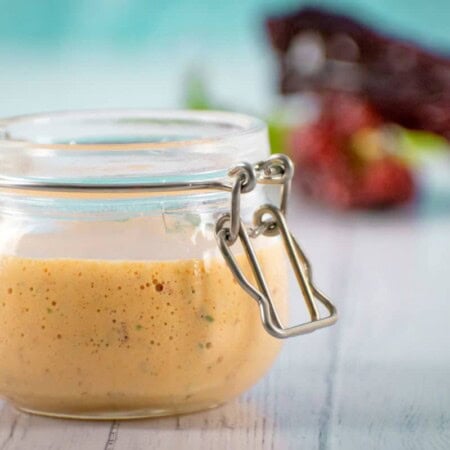 A blended chipotle sauce in a glass jar, ready to drizzle over dinner