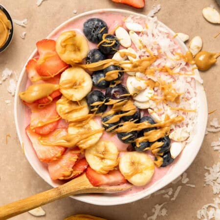 Berry smoothie bowl topped with peanut butter, made in a blender